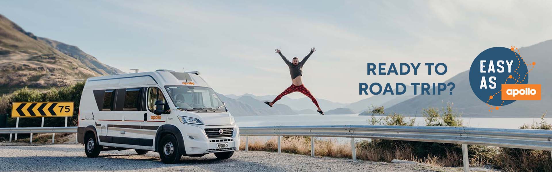 Man jumping in front of New Zealand mountain and Apollo rental camper